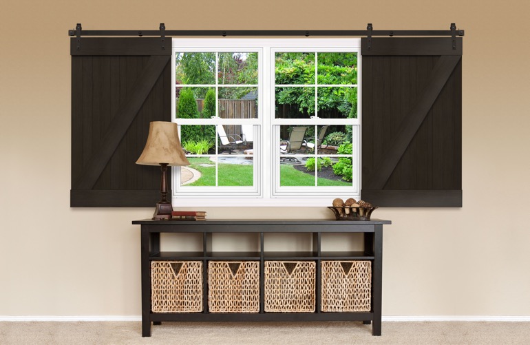 Dark brown sliding barn doors on a window 